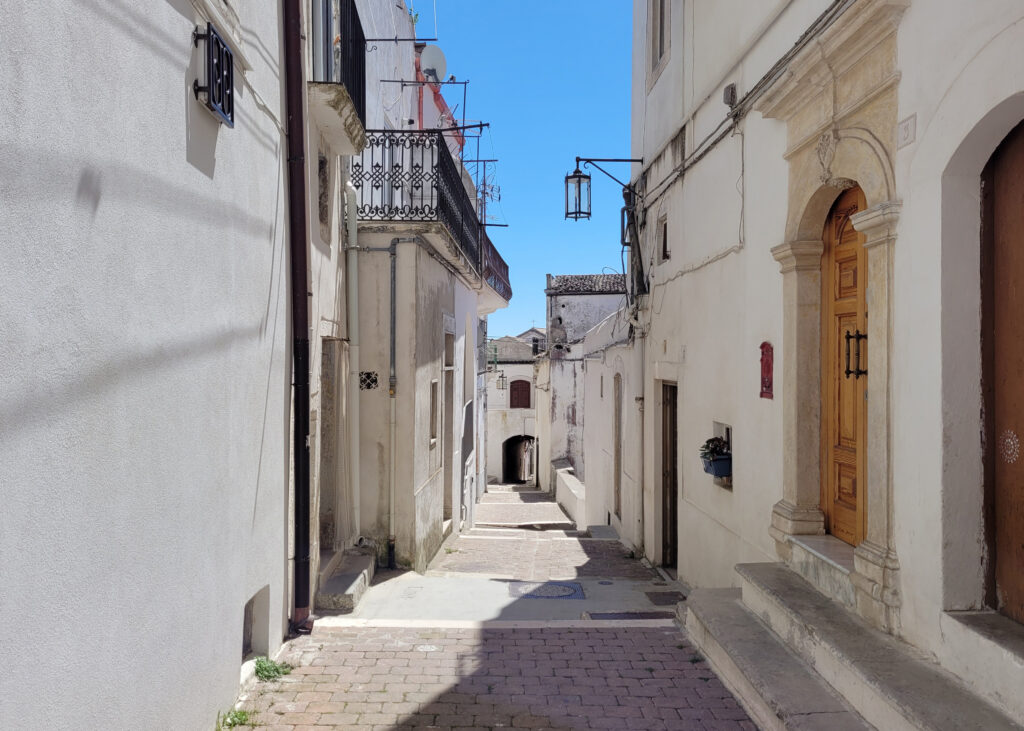 Vicolo lastricato nel centro storico di Monte Sant'Angelo con case bianche